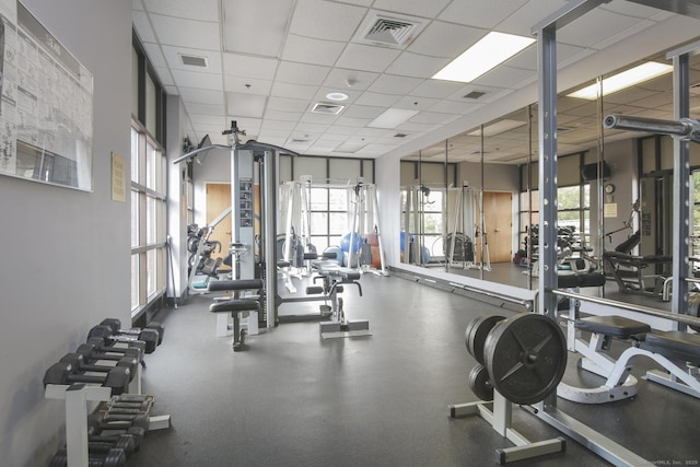 exercise room featuring visible vents and a drop ceiling