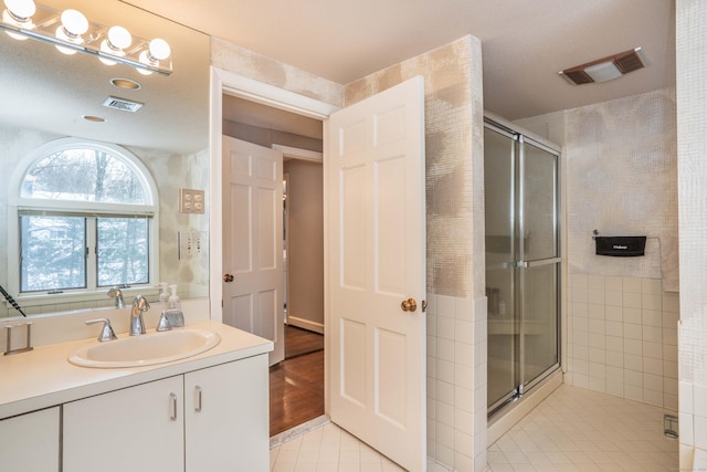 bathroom featuring vanity, tile patterned floors, and walk in shower