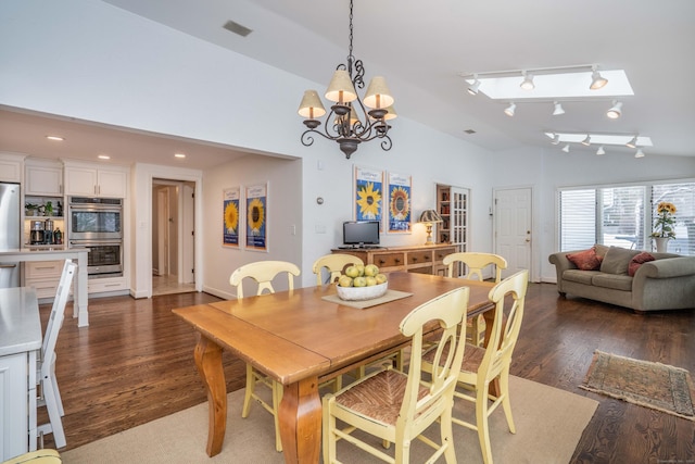 dining area with an inviting chandelier, vaulted ceiling, dark hardwood / wood-style floors, and track lighting