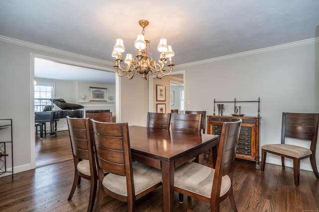 dining space featuring crown molding, dark wood-type flooring, and a chandelier