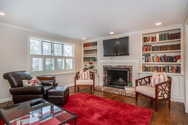 living room featuring ornamental molding, dark hardwood / wood-style floors, built in features, and a fireplace