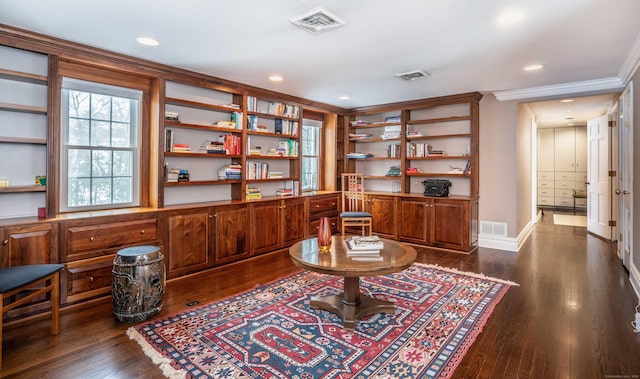 living area featuring crown molding and dark wood-type flooring