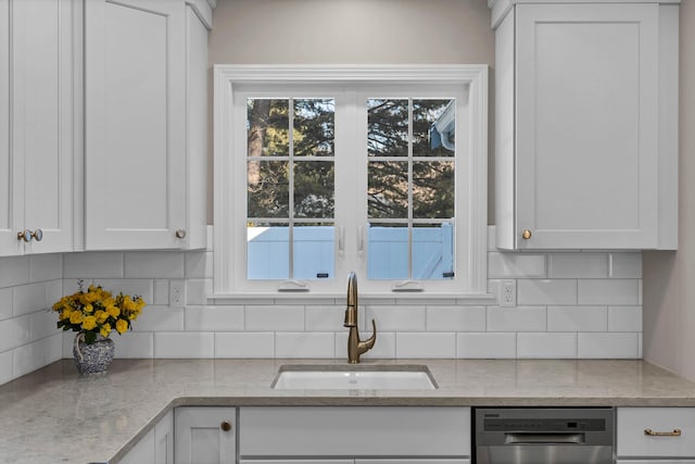 kitchen featuring white cabinetry, sink, and a wealth of natural light