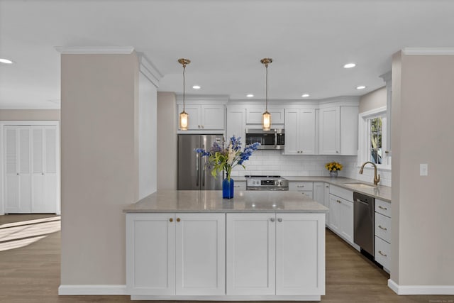 kitchen featuring white cabinetry, appliances with stainless steel finishes, decorative light fixtures, and light stone countertops