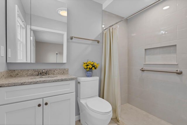 bathroom with vanity, toilet, and a shower with shower curtain