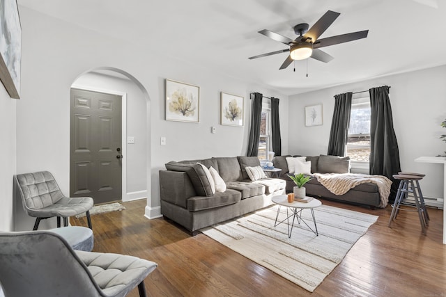 living room with ceiling fan and dark hardwood / wood-style flooring