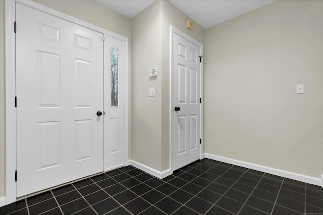 foyer entrance with dark tile patterned flooring