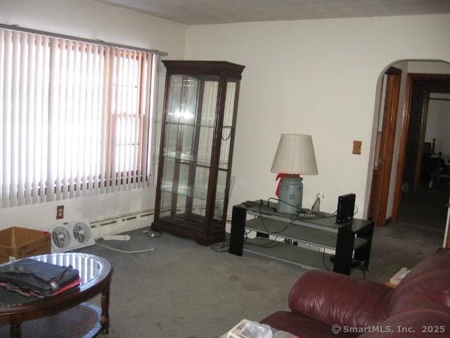 living room with a baseboard radiator and carpet flooring