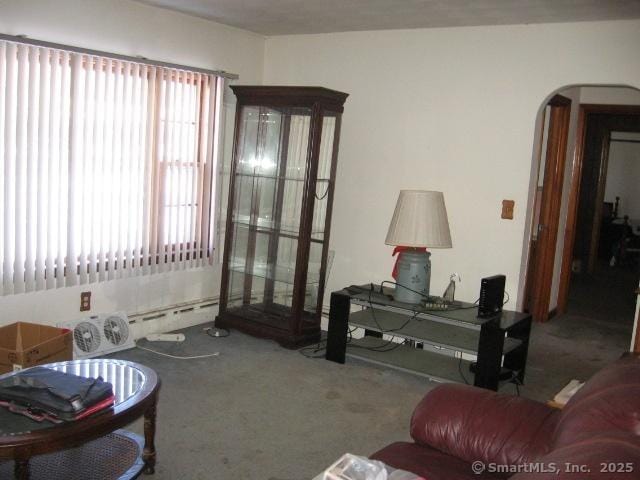 38 New Haven Rd, Seymour, CT 06483 - carpeted living room featuring arched walkways, healthy amount of natural light, and baseboard heating