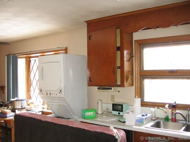 38 New Haven Rd, Seymour, CT 06483 - kitchen with stacked washer / drying machine, a sink, plenty of natural light, and light countertops