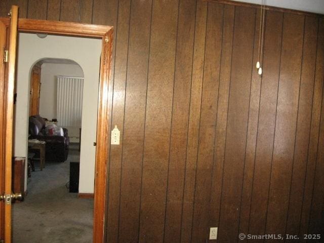 interior space with wooden walls and carpet