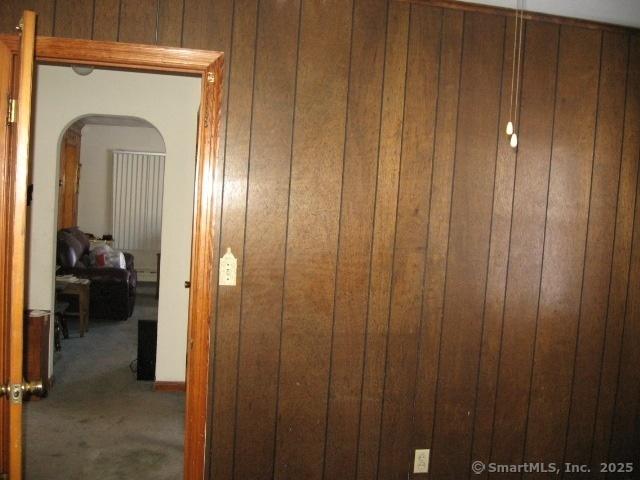 38 New Haven Rd, Seymour, CT 06483 - hallway featuring arched walkways, carpet flooring, and wood walls