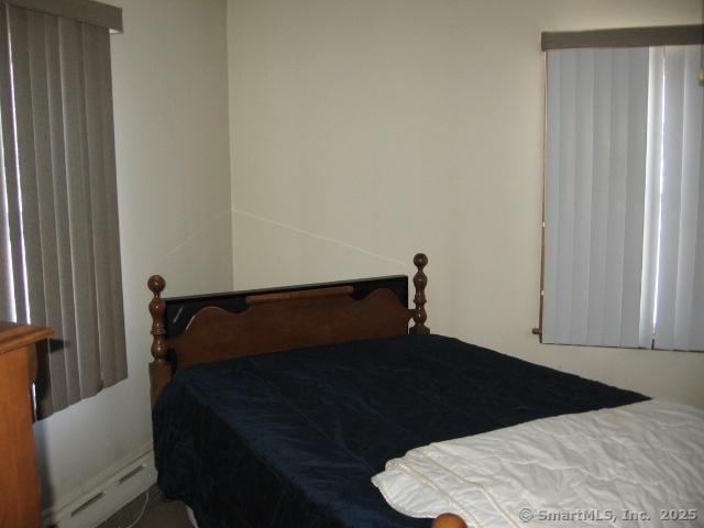 bedroom with a baseboard heating unit