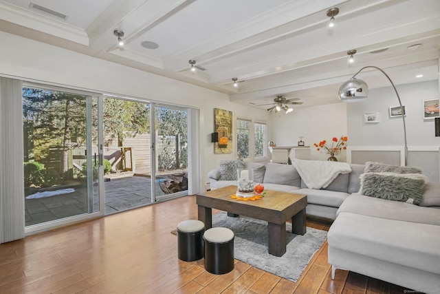 living room with beam ceiling, ornamental molding, ceiling fan, and hardwood / wood-style flooring