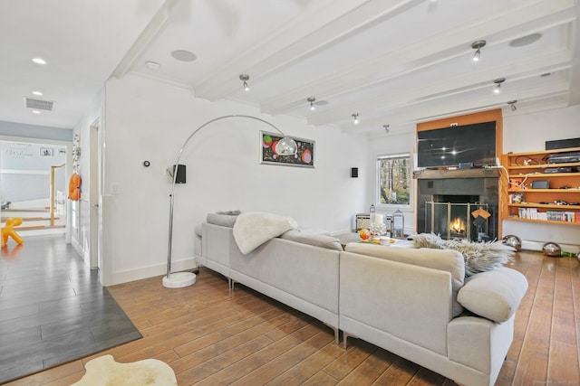 living room with hardwood / wood-style floors and beamed ceiling