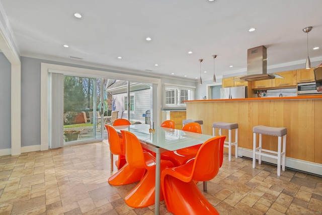 dining space with a baseboard radiator and ornamental molding