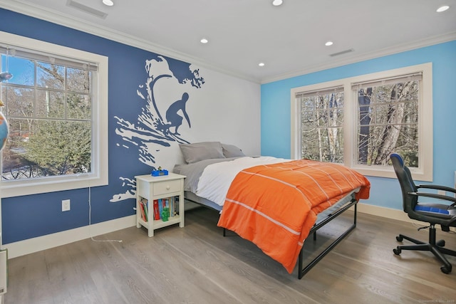 bedroom featuring hardwood / wood-style floors and crown molding