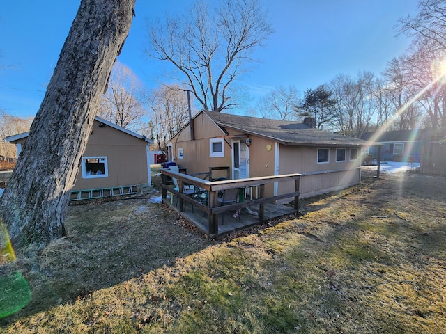 rear view of property featuring a lawn