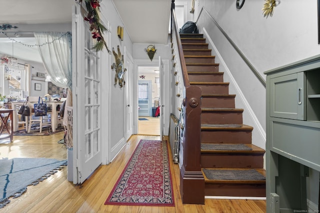 staircase with hardwood / wood-style flooring