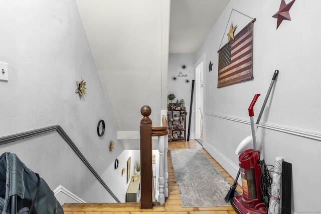 stairs featuring hardwood / wood-style flooring