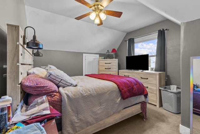 bedroom featuring lofted ceiling, light colored carpet, and ceiling fan