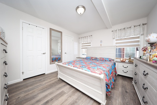 bedroom featuring dark hardwood / wood-style flooring and beam ceiling