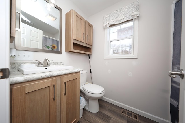 bathroom featuring vanity, hardwood / wood-style floors, and toilet