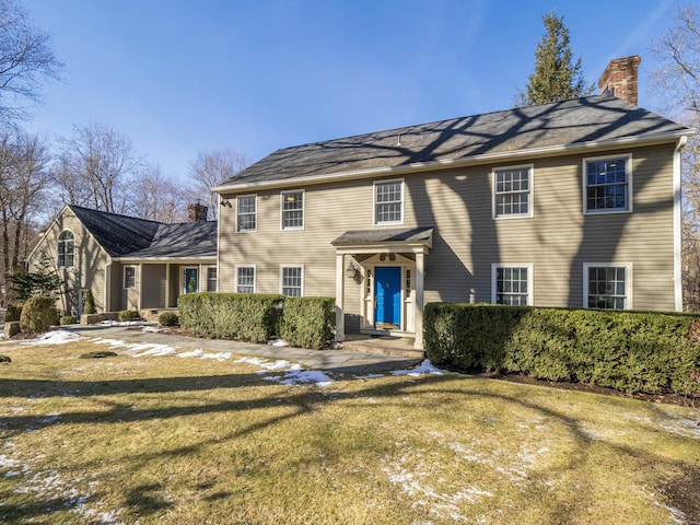 colonial-style house with a front lawn