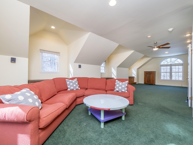 living room featuring ceiling fan, lofted ceiling, and carpet floors