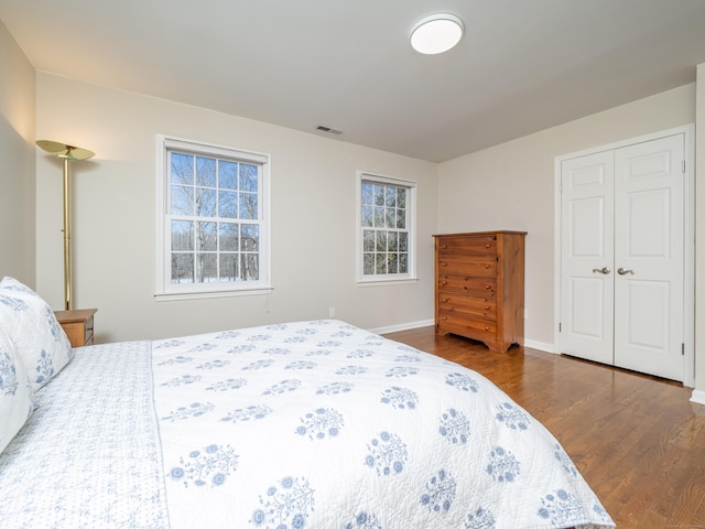 bedroom featuring a closet and dark hardwood / wood-style floors