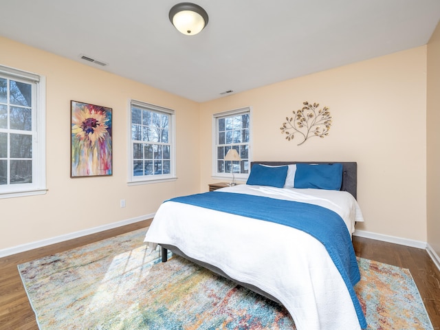 bedroom with dark hardwood / wood-style flooring