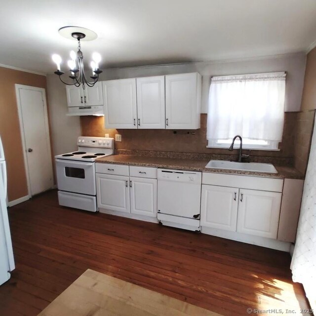 kitchen featuring sink, white appliances, white cabinetry, dark hardwood / wood-style floors, and a notable chandelier