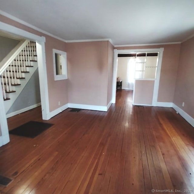 unfurnished living room with crown molding and dark hardwood / wood-style floors