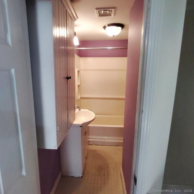 hall featuring sink and light hardwood / wood-style floors