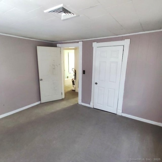 unfurnished bedroom with ornamental molding and a closet