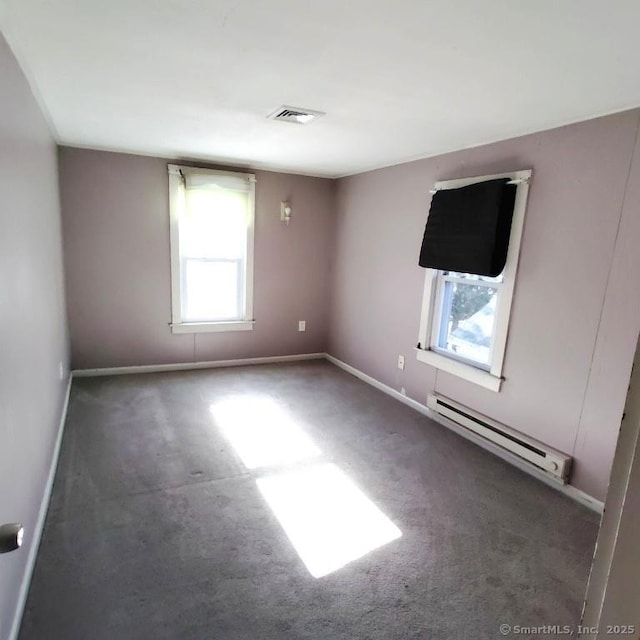 unfurnished room with a baseboard radiator