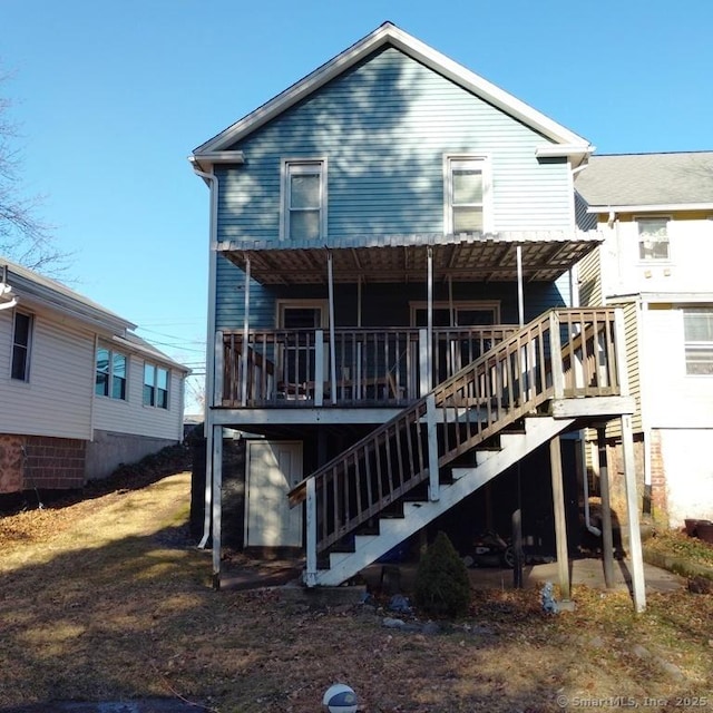 back of house with a deck