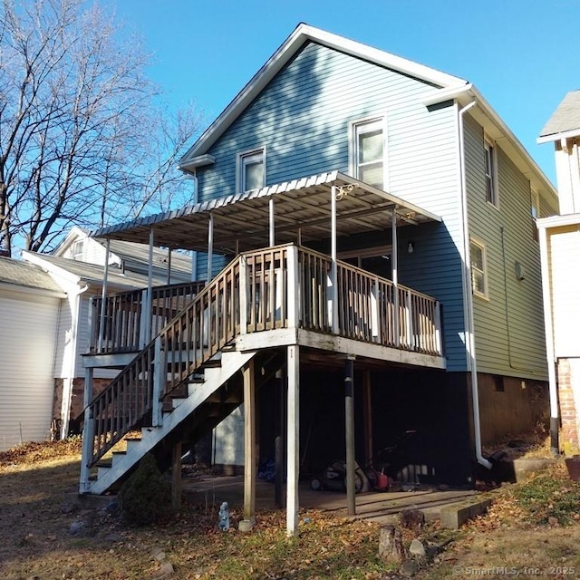 back of house featuring a wooden deck