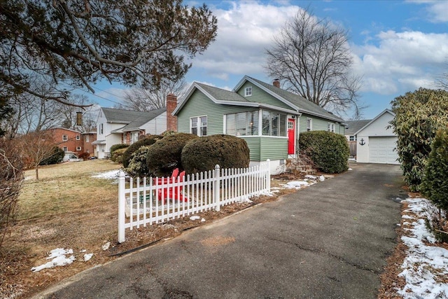 view of front of property featuring an outbuilding and a garage