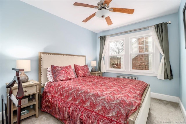 carpeted bedroom featuring ceiling fan and radiator heating unit