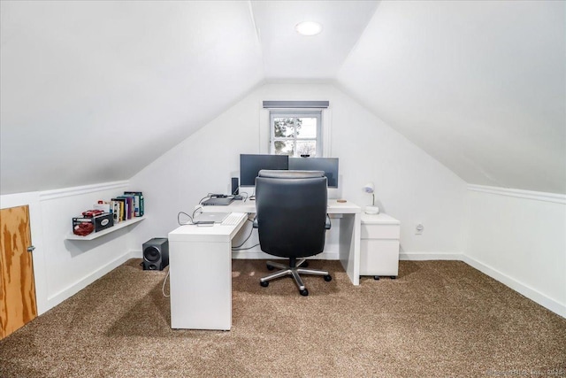 carpeted office space with vaulted ceiling