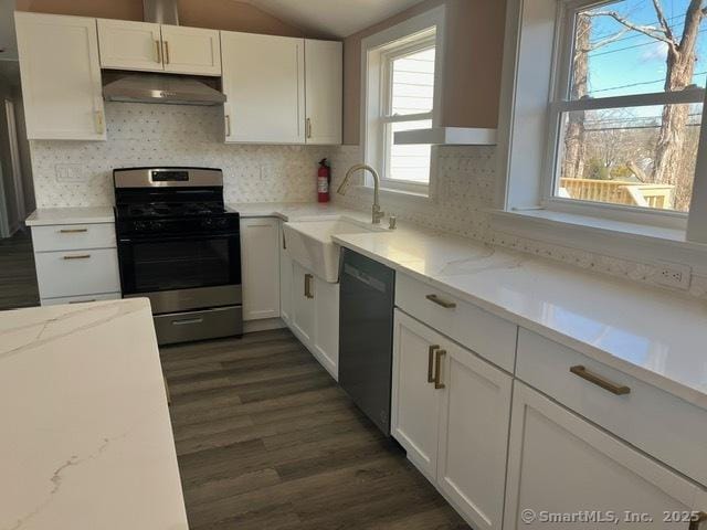 kitchen with sink, black dishwasher, light stone countertops, gas stove, and white cabinets