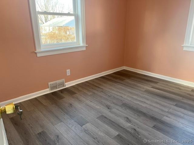 empty room with hardwood / wood-style floors