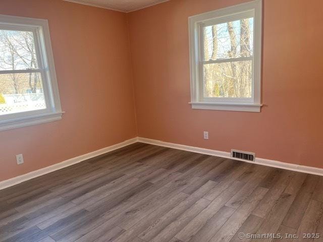 unfurnished room with dark wood-type flooring