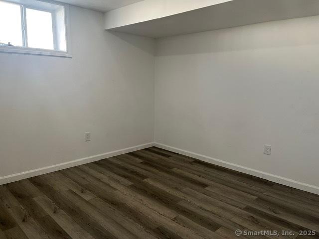 basement featuring dark wood-type flooring