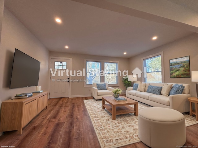 living room featuring a healthy amount of sunlight and dark hardwood / wood-style floors