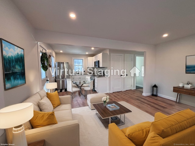 living room featuring sink and light hardwood / wood-style floors