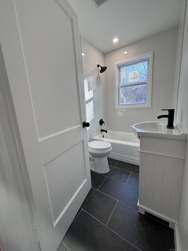 full bathroom with tiled shower / bath combo, vanity, tile patterned floors, and toilet