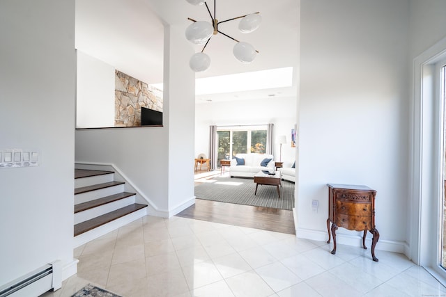 foyer entrance with a baseboard heating unit and light tile patterned flooring