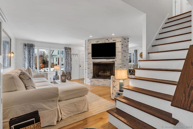 living room with a fireplace and wood-type flooring